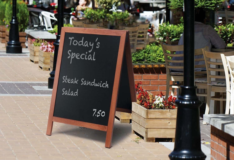 Restaurant Sandwich Boards featuring write-on chalkboard in front of a outdoor dining