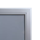 Corner detail of poster frame with swing door