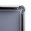 Close up of back left corner of thin silver snap open poster frame